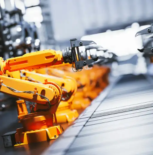 Robotic arms along assembly line in factory aura